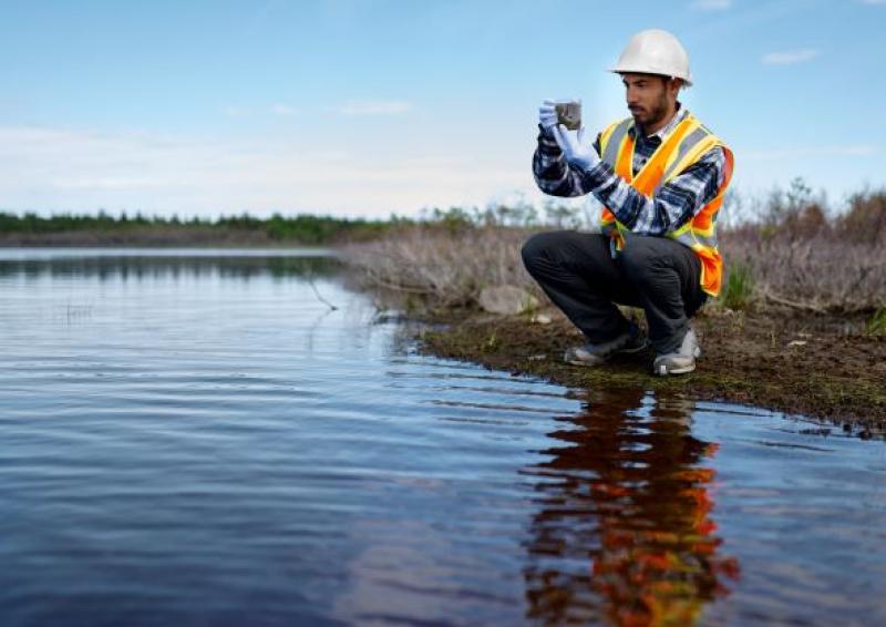 Illustrative image of person who is measuring water quality.