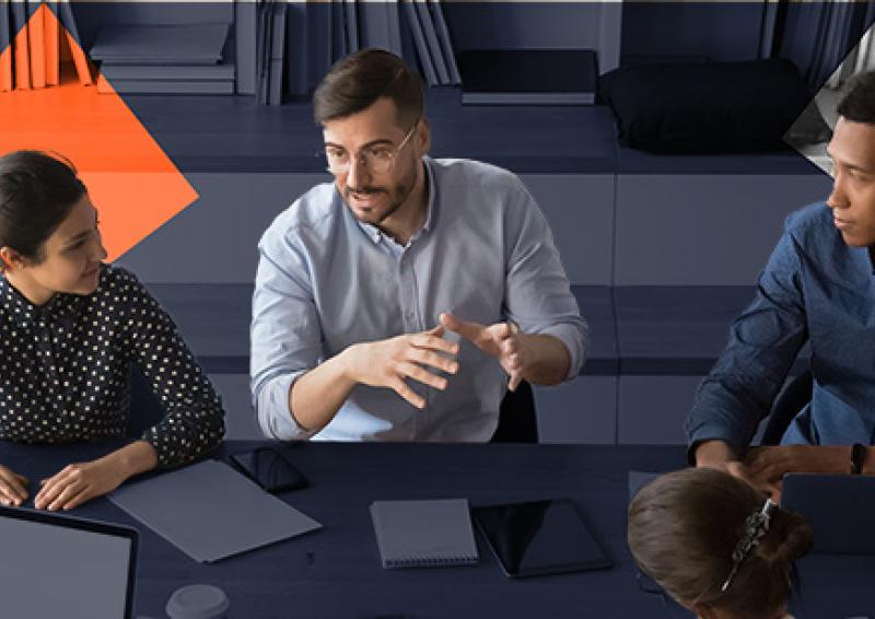 Group of people sitting around a table discussing a topic