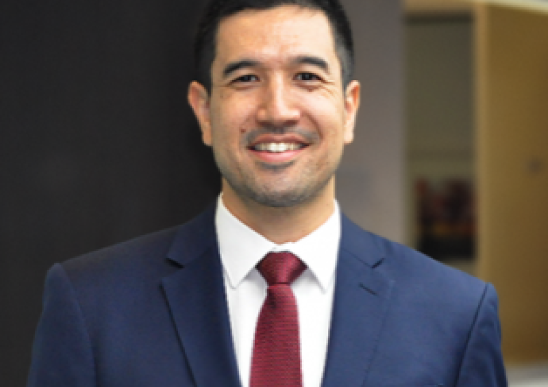 A head and shoulders photo of Joshua Saunders in a suit and tie.