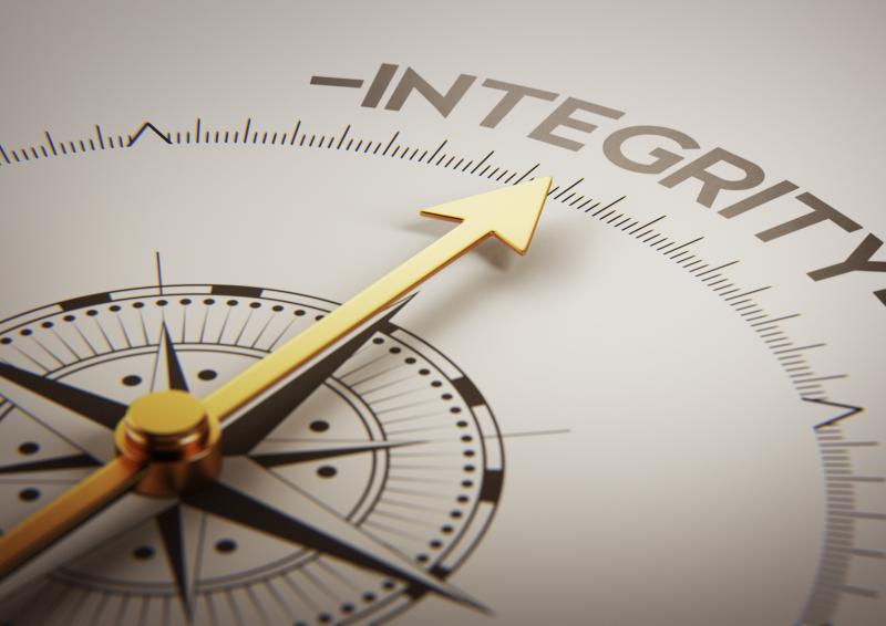 Clock face with large hand pointing to the word ‘Integrity’.