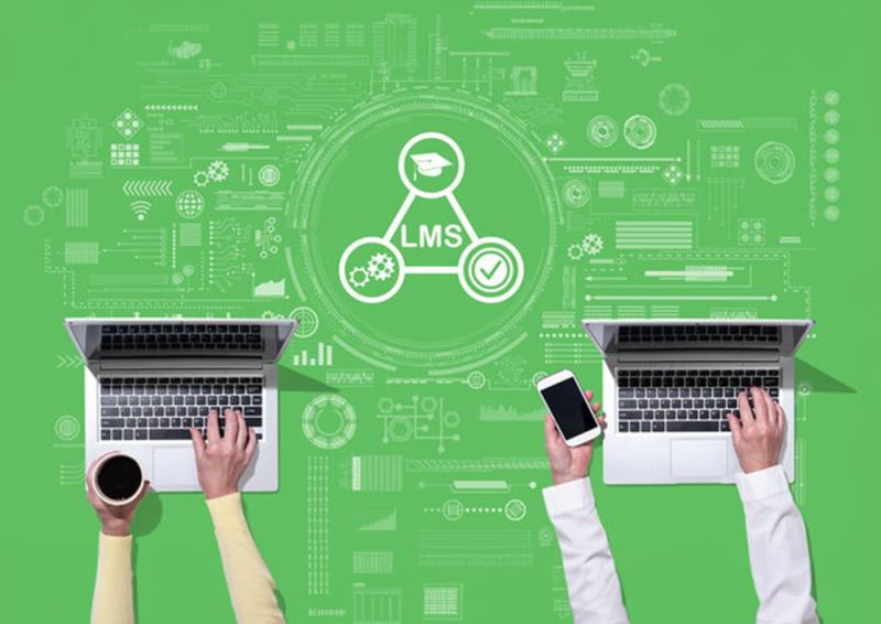 An illustrative image of two computers with two people’s hands at them with a graphical representation of a triangle featuring the acronym LMS (which stands for Learning Management System). 