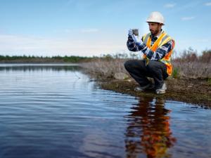 Illustrative image of person who is measuring water quality.