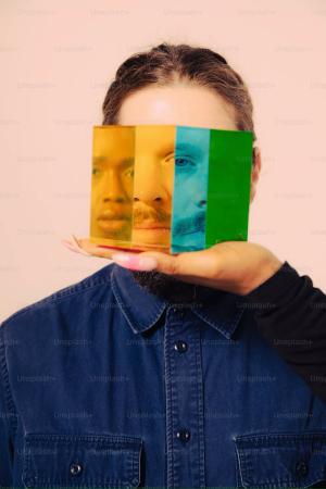 Photo credit to Nick Fancher. A photo of a woman holding a piece of paper with a picture of a man's face